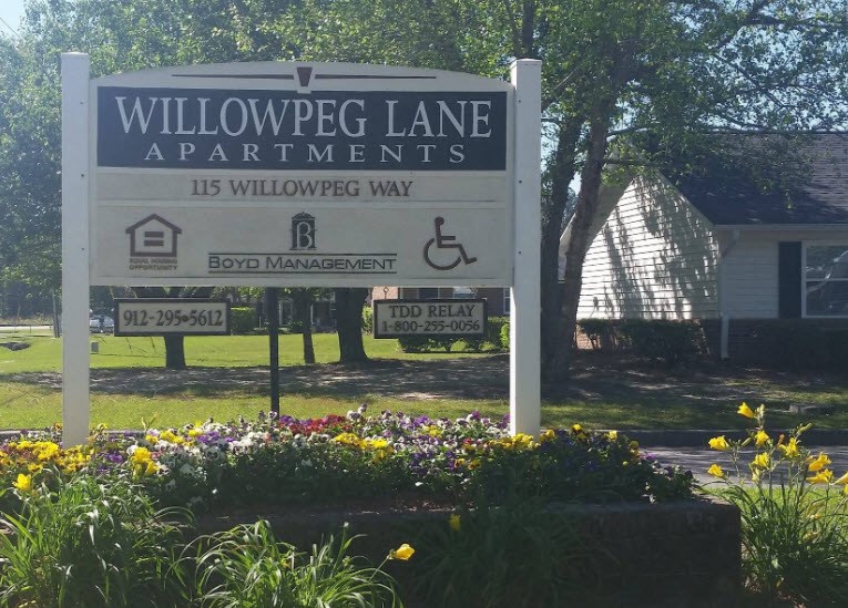 a sign apartments in front of a house