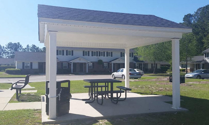 a pavilion with a picnic table and
