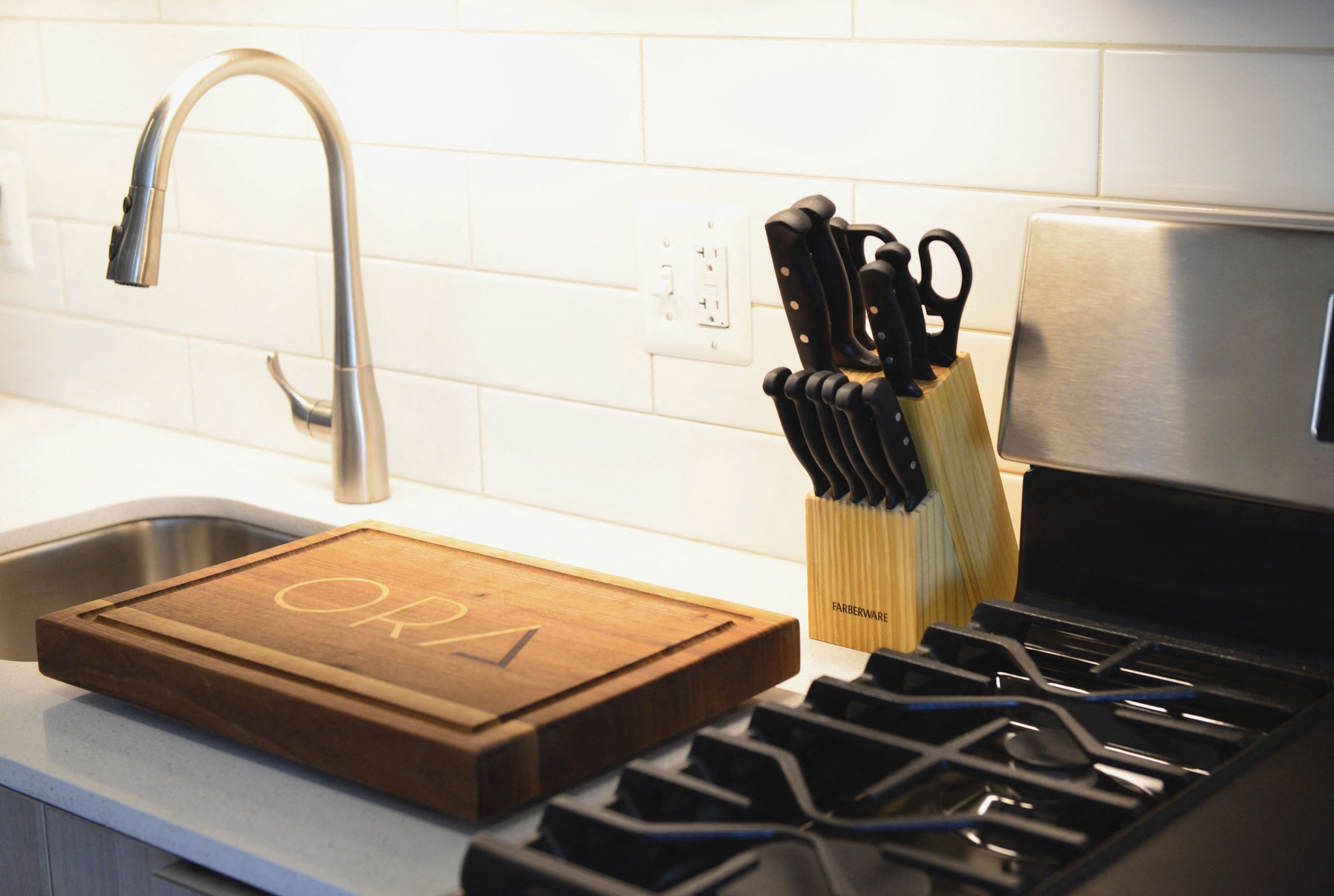 a wooden cutting board sitting on top of a kitchen stove