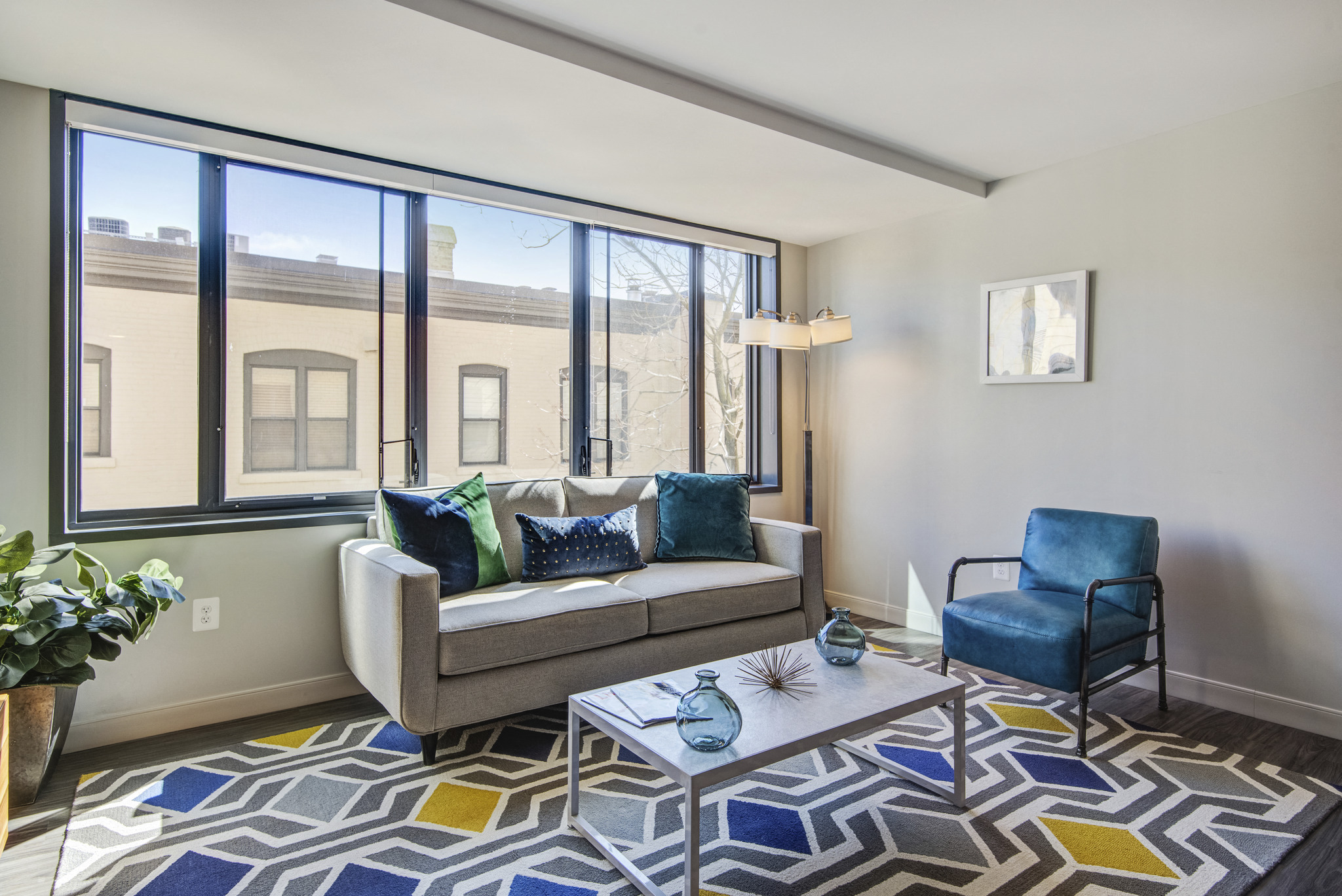 a living room with large windows and a couch and a coffee table