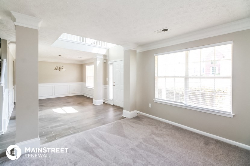 an empty living room with a large window