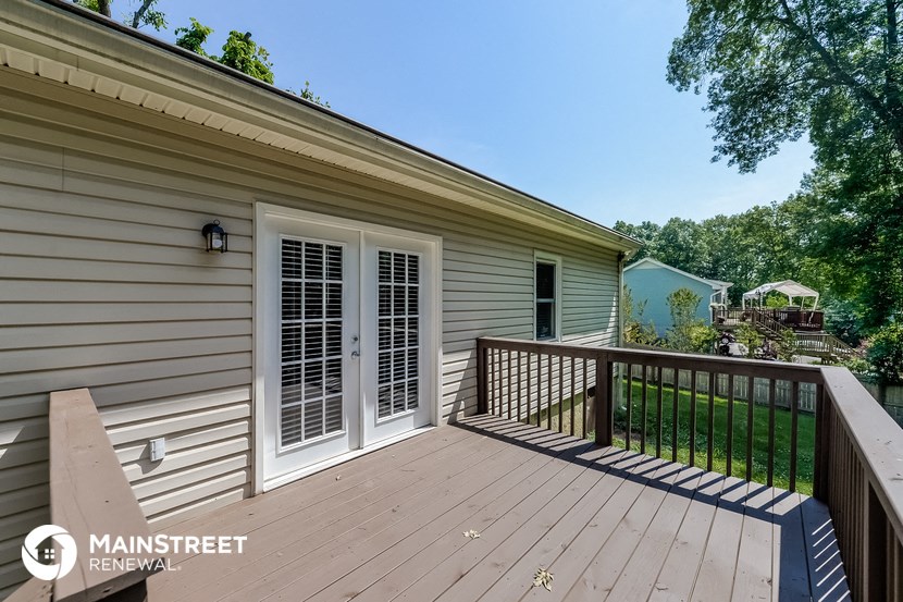 the deck is off the back of the house and overlooks the yard