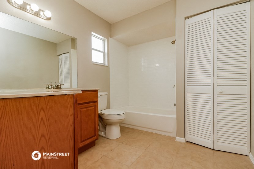 a bathroom with a toilet and a sink and a shower