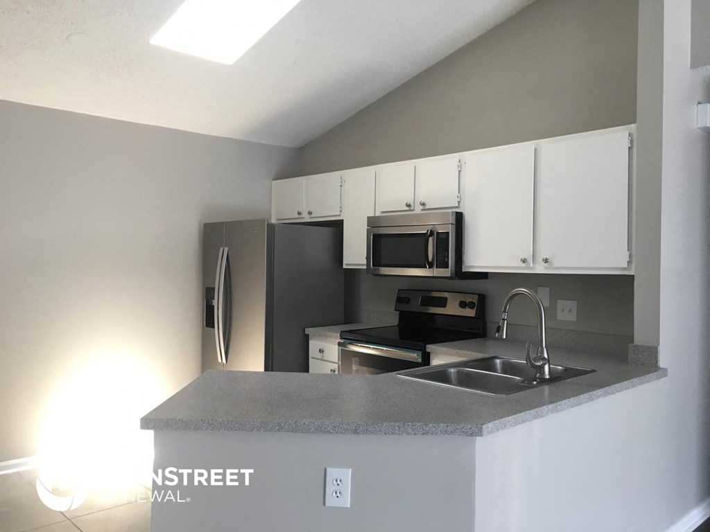 a kitchen with a counter top and a sink