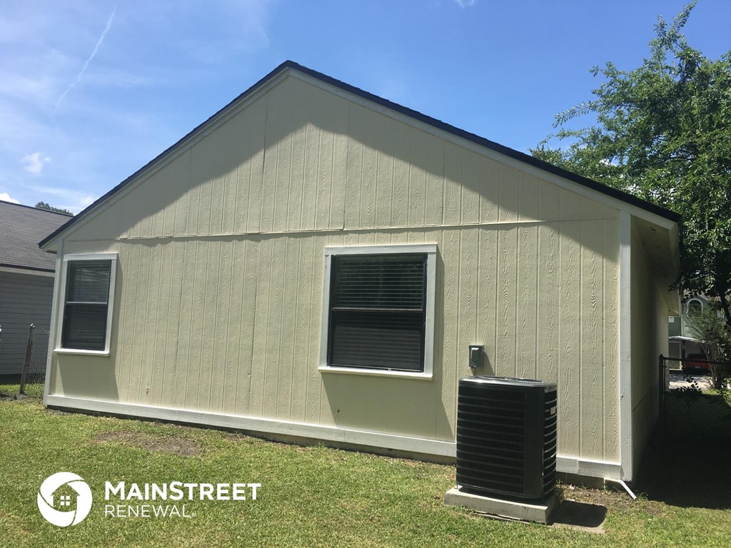 the side of a house with a radiator in front of it