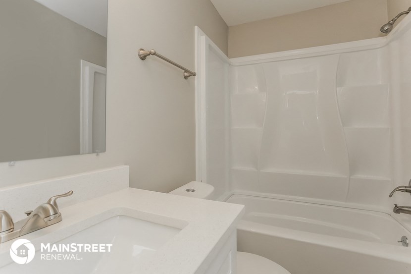 a bathroom with a sink and a shower and a toilet