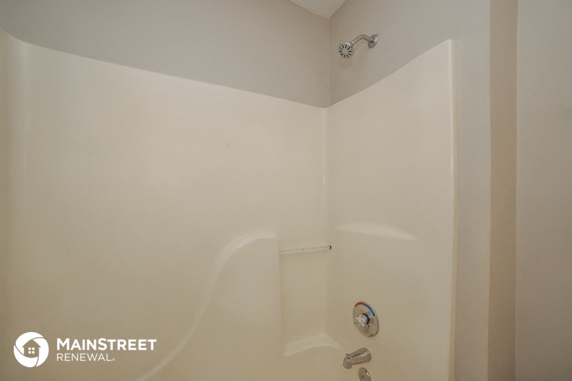 a small bathroom with a shower and a sink