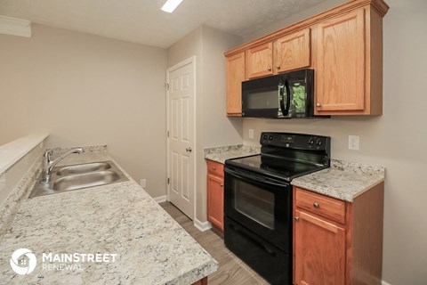 a kitchen with black appliances and granite counter tops