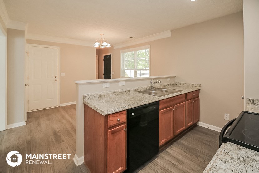 the kitchen has granite counter tops and wooden cabinets