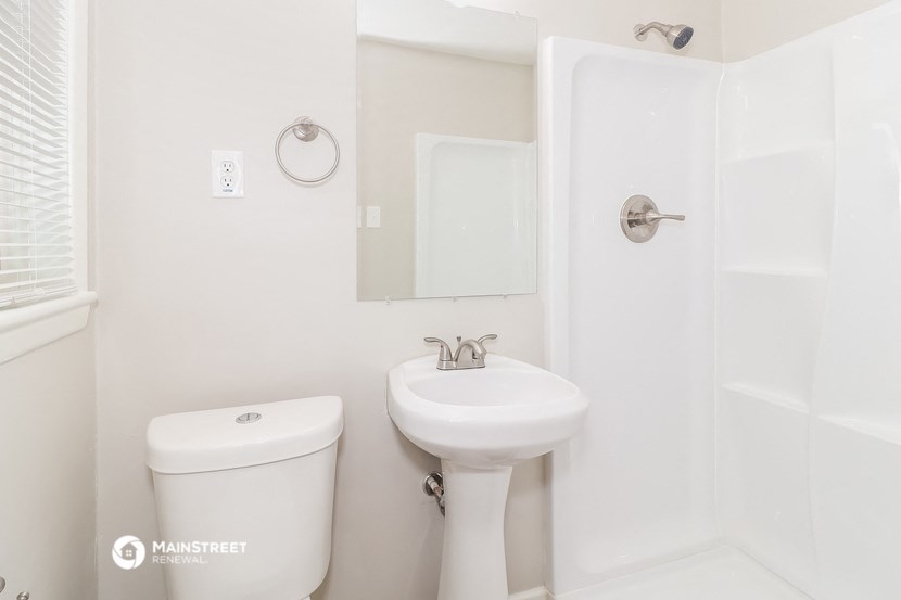 a bathroom with a sink and a toilet and a shower