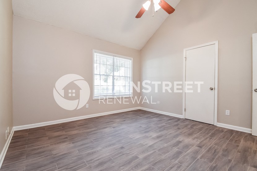 a room with a hard wood floor and a white door