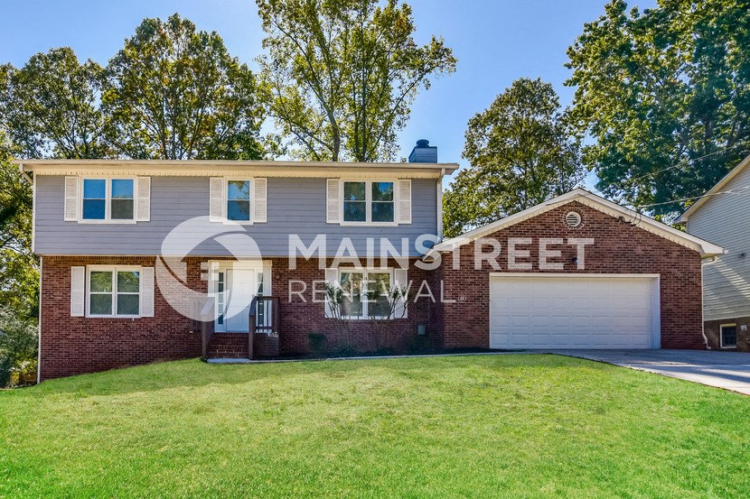 a house with a lawn and a garage