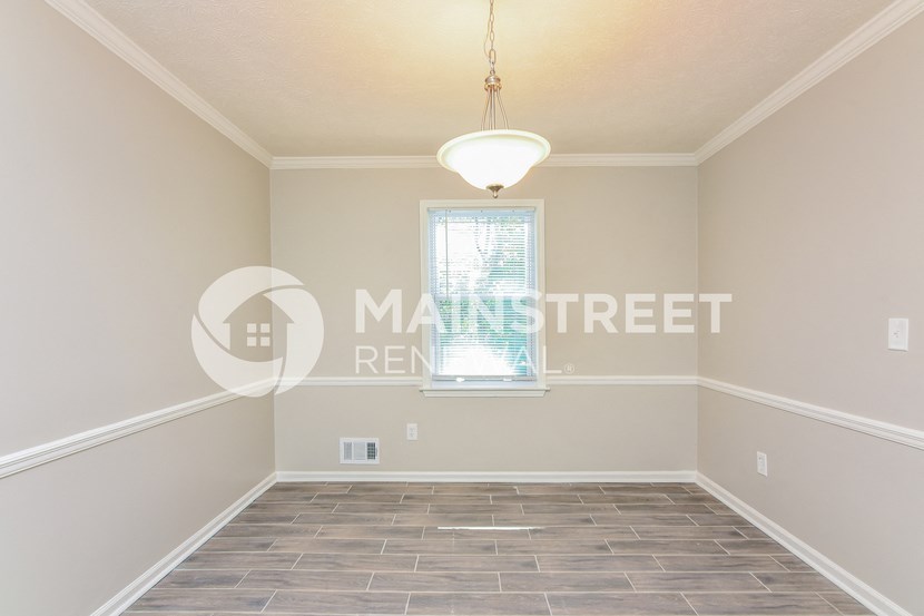 a bedroom with a large empty room and a window