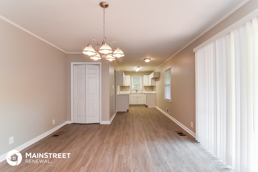 the living room and dining room of an apartment