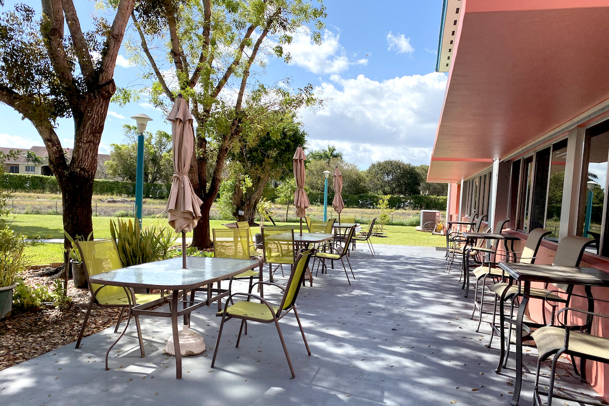 outdoor patio with tables with umbrellas and chairs