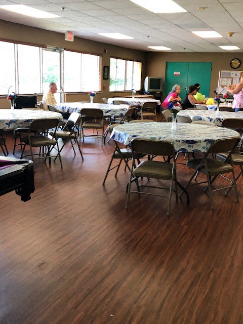 a group of people sitting at tables in a dining room