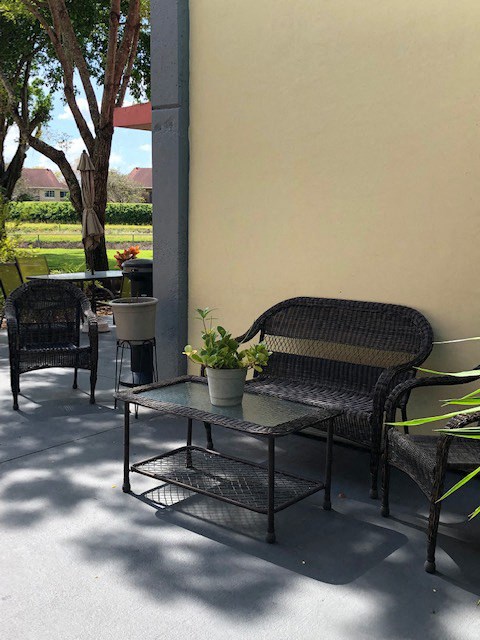 cozy patio with tables and benches at Deedco Gardens