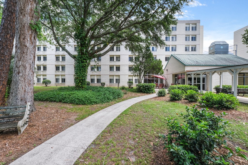 Neatly maintained sidewalk walking path outside of Sundale Manor Apartments