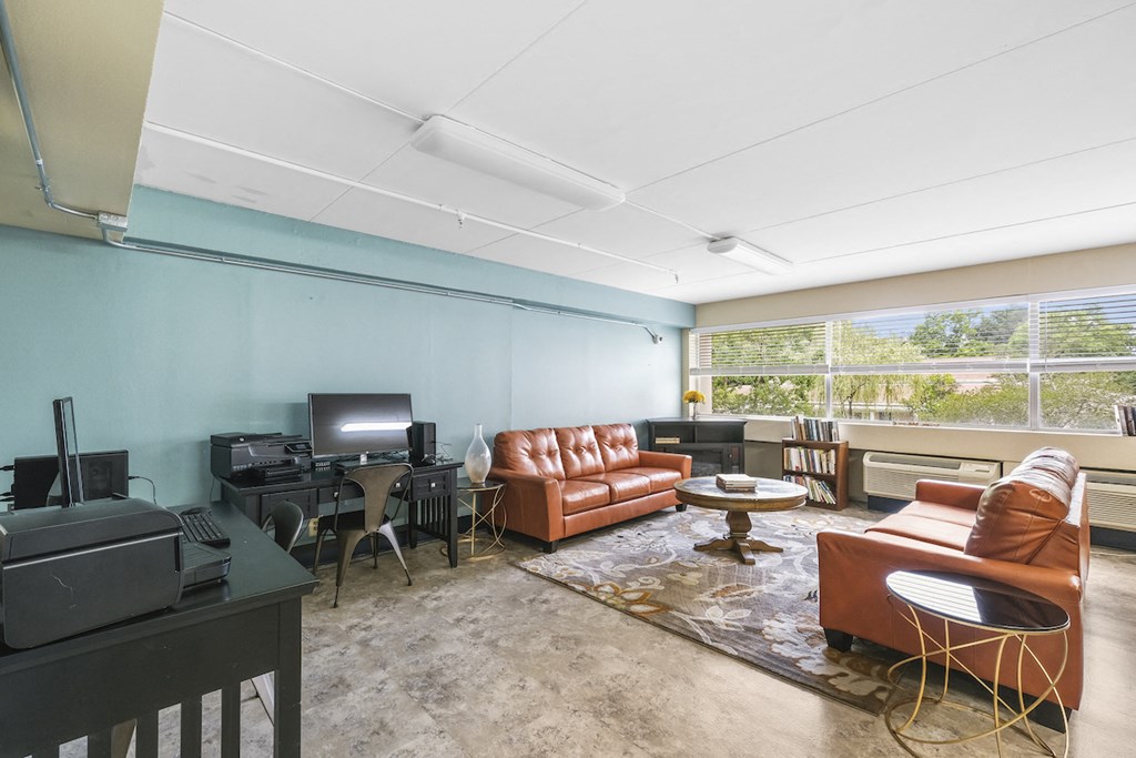 library with large windows, comfortable seating, and computer & printing stations