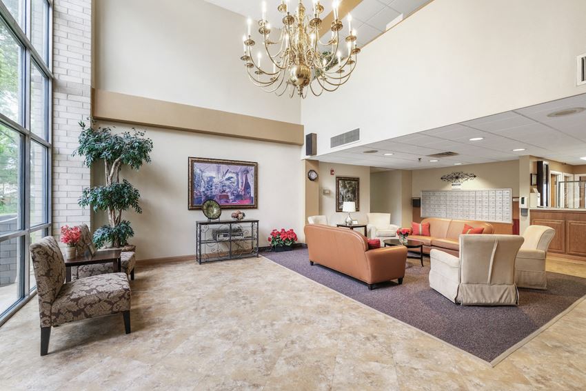 spacious lobby with chandelier, lots of seating, and massive windows - Photo Gallery 1