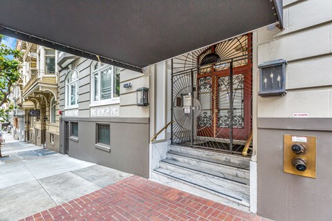 A building with a red brick walkway in front of it.