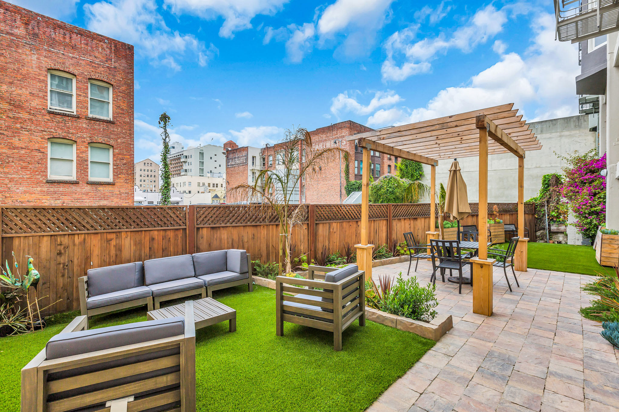 A backyard with a wooden fence and a patio area.