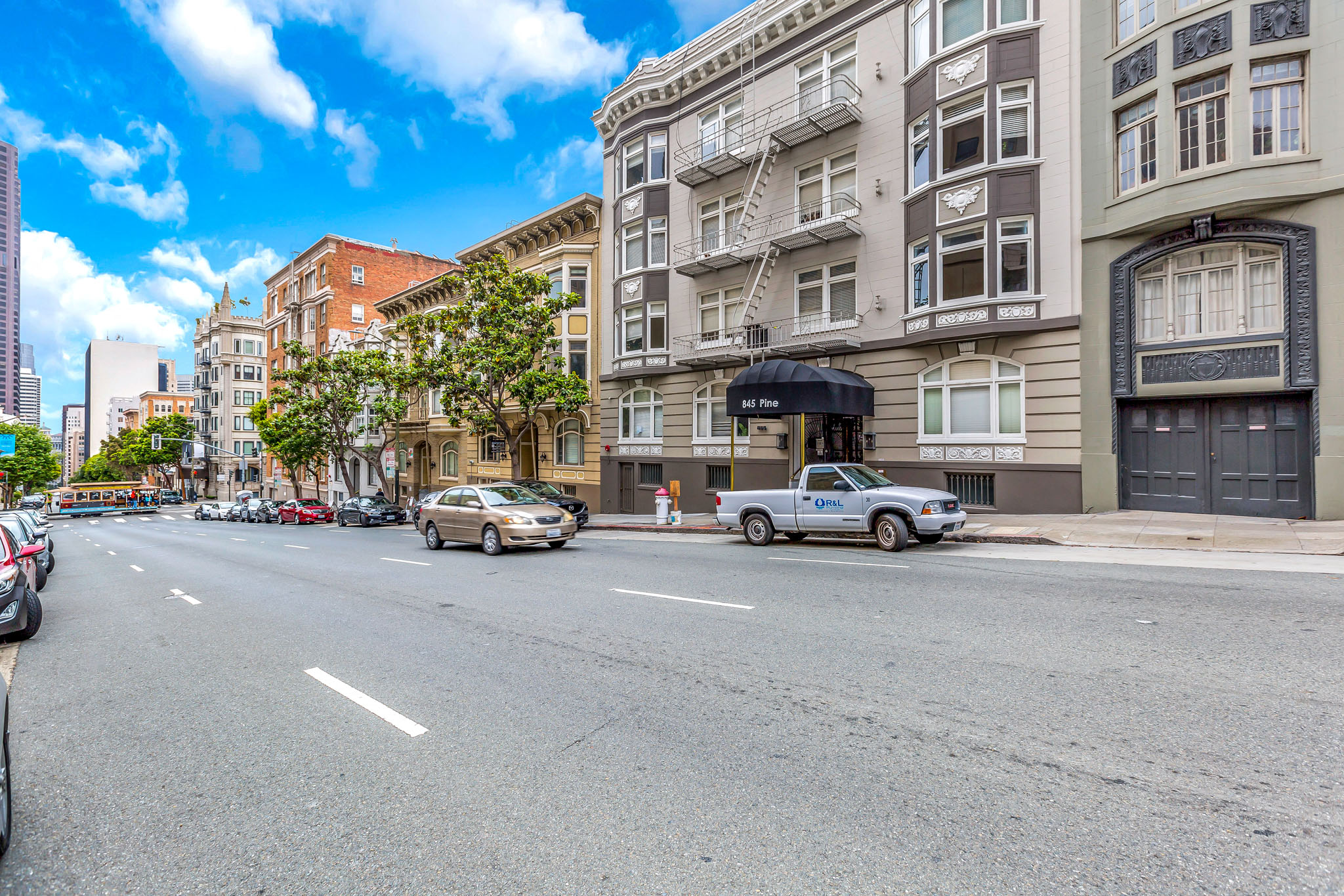 A street view with cars and buildings on both sides.