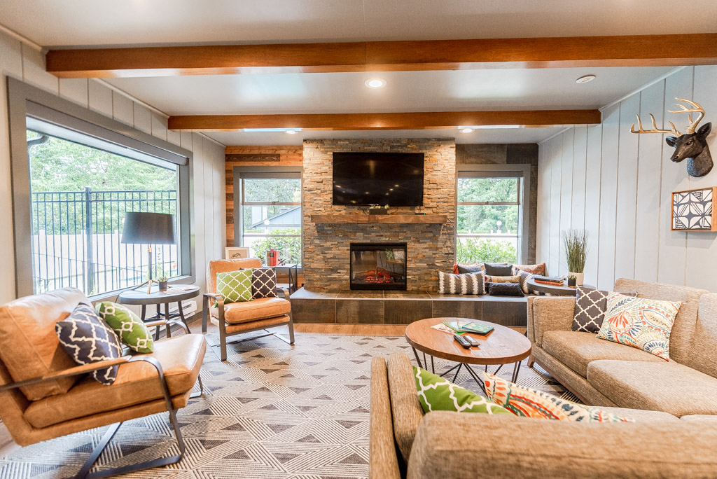 a living room with couches and chairs and a fireplace