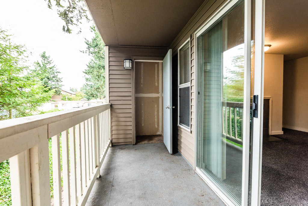 Tacoma Apartments - Sienna Apartments - Deck, Storage Room, Living Room, and Fireplace