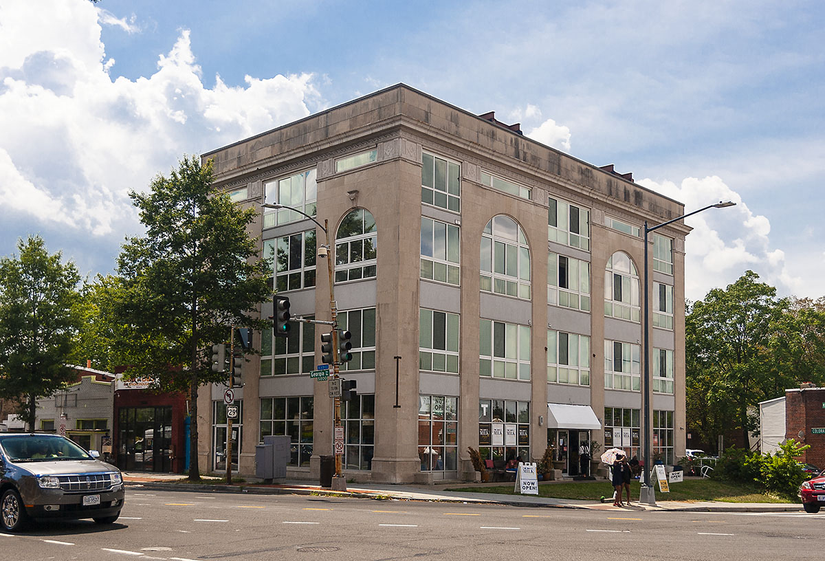 a large building on the corner of a city street
