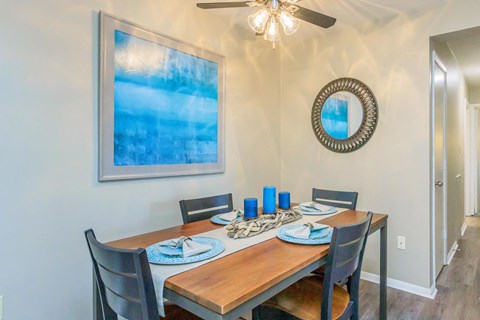 a dining room with a wooden table and chairs