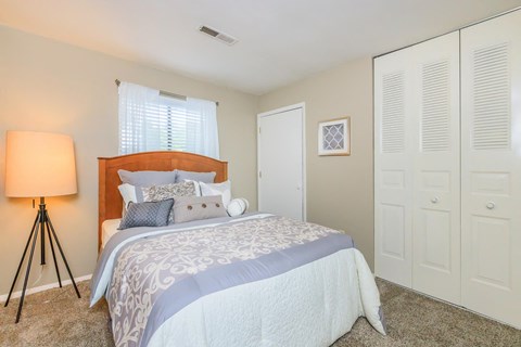 a bedroom with a bed and a closet