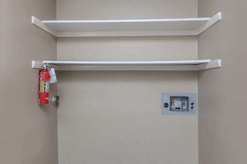 a fire hydrant hanging on the wall of a bathroom door