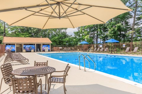 our swimming pool is equipped with tables and chairs and umbrellas