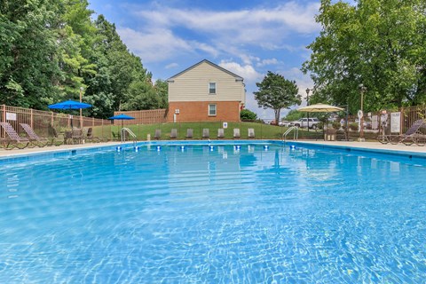 a swimming pool with a house in the background