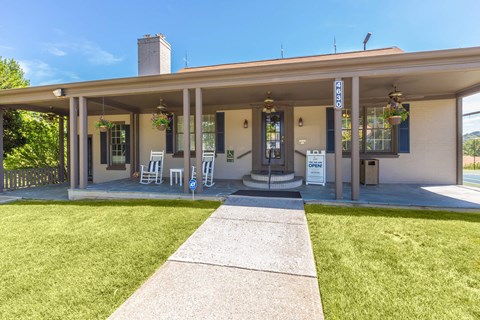 a building with a lawn and chairs in front of it