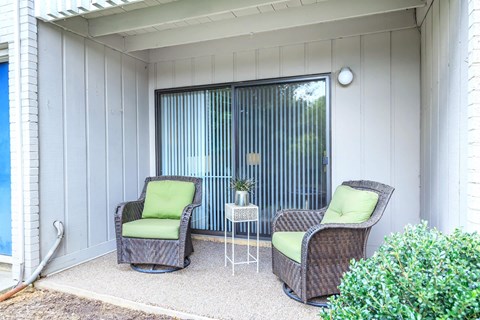 a patio with two chairs and a table