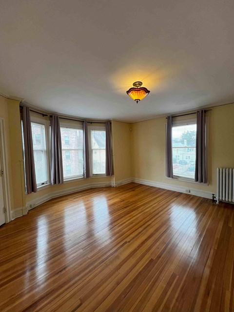 A room with wooden floors and a ceiling light.