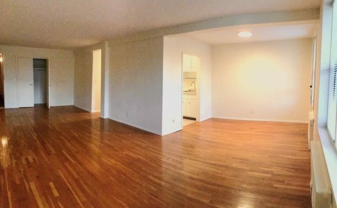 A room with wooden floors and white walls.
