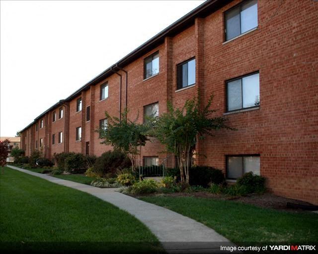 a sidewalk in front of a brick building