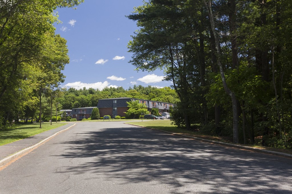 a street with a building on the side of a road