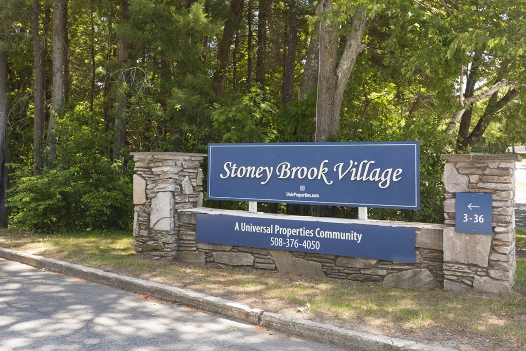 a sign in front of trees