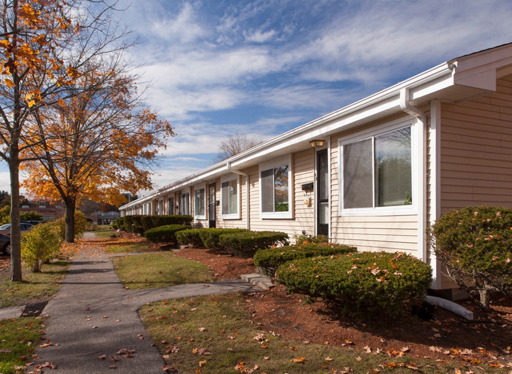 a white house with a sidewalk in front of it