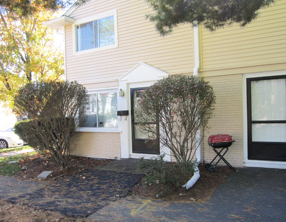 the front of the house has a walkway and a front door