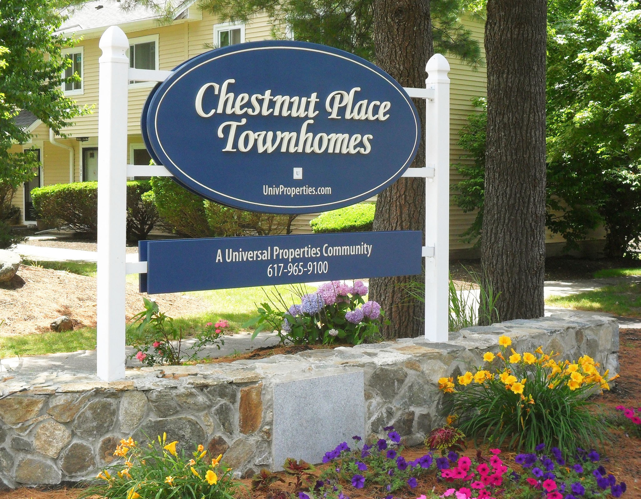 a sign for chesnut place townhomes in front of a house