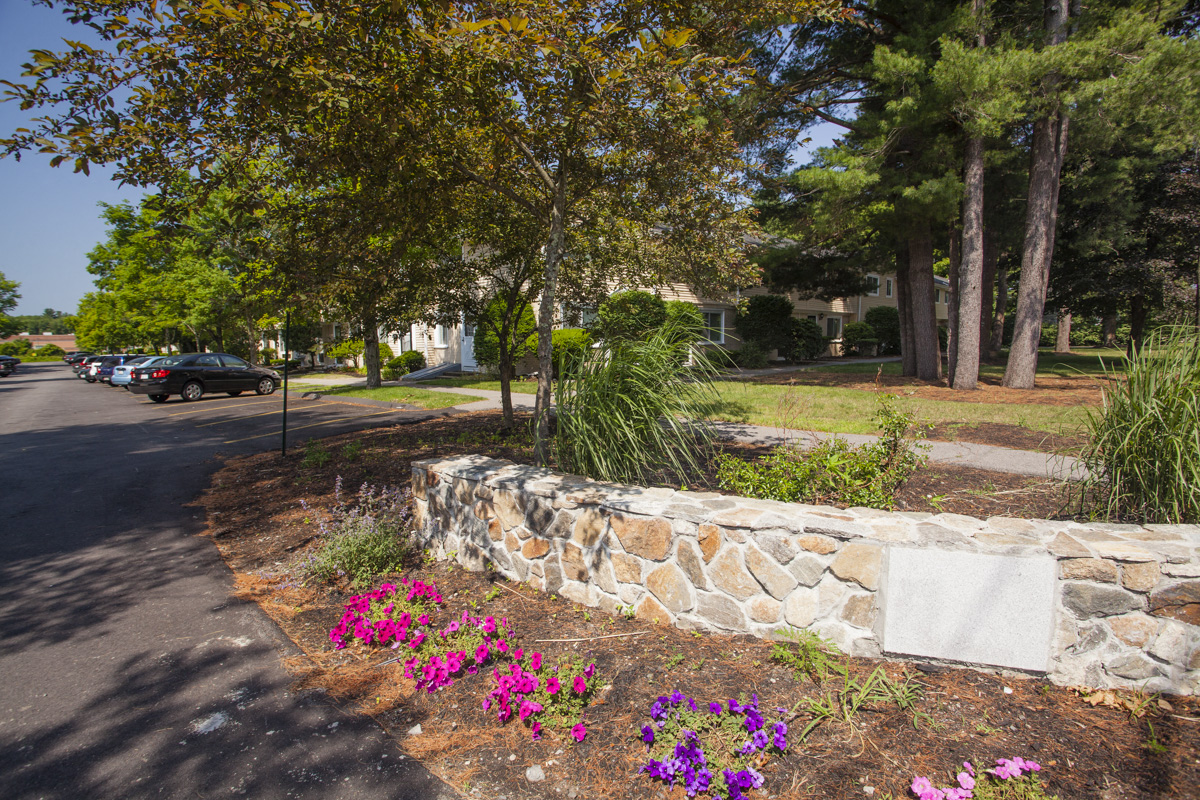 a stone retaining wall on the side of a street