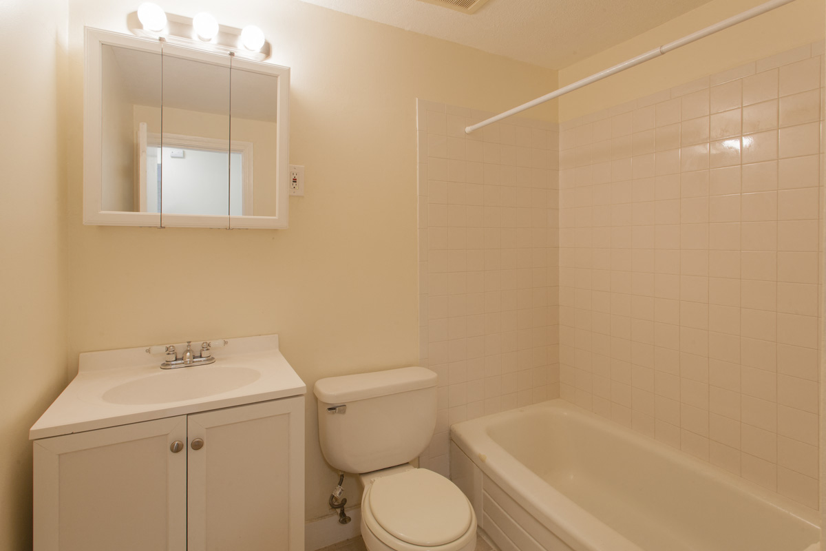 a bathroom with a sink toilet and a bath tub