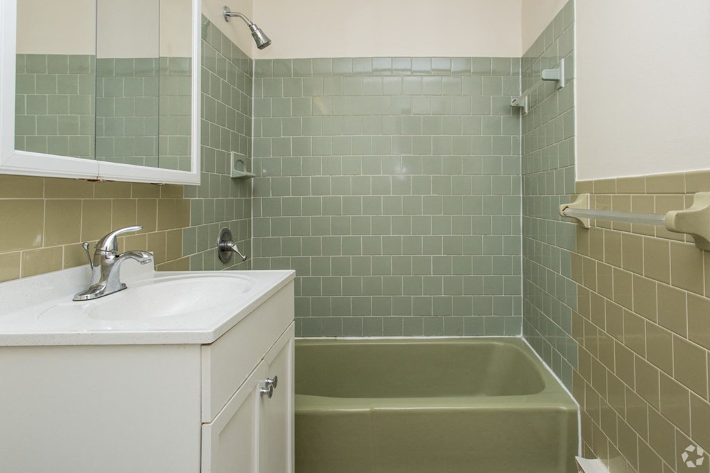 a small bathroom with a sink and a bath tub