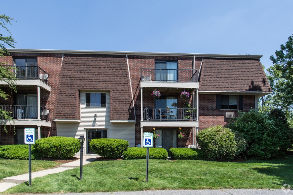 an apartment building with parking signs in front of it