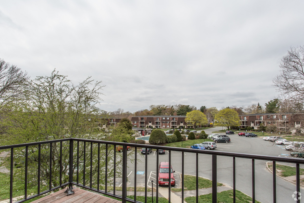 a balcony with a view of a parking lot